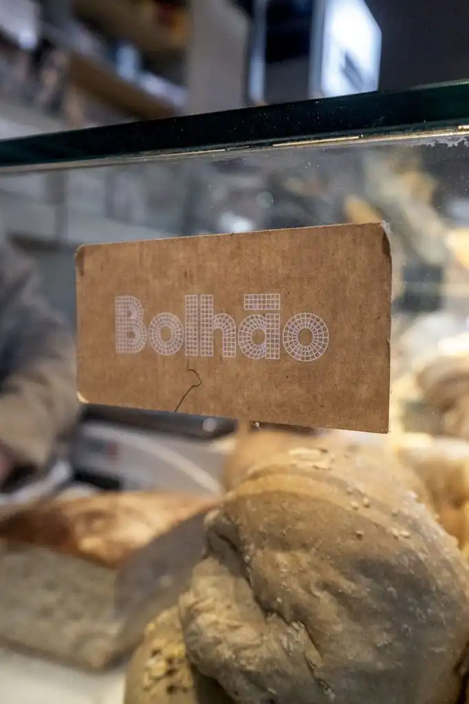 Bolhao bread label on a glass display case with rustic loaves visible behind