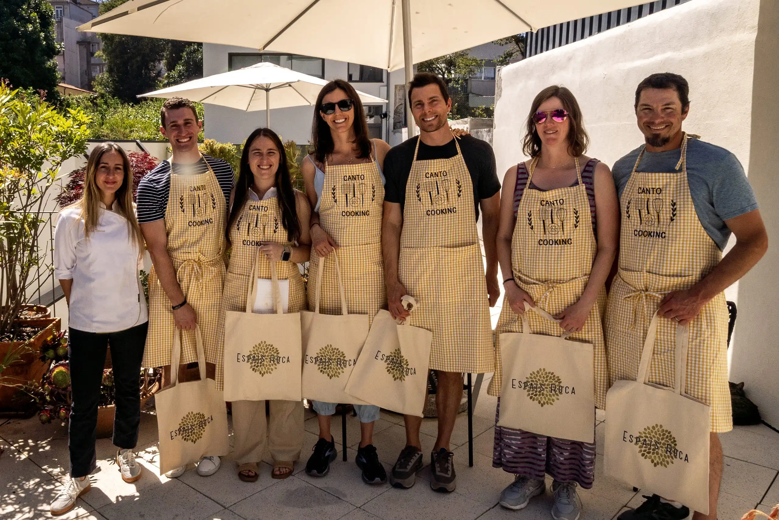 Guests wearing Canto Cooking aprons after a Portuguese cooking class in Porto