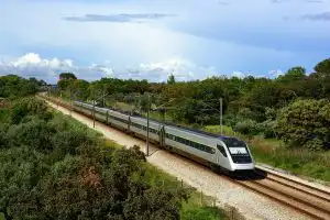 CP Alfa Pendular high-speed train travelling through green Portuguese countryside