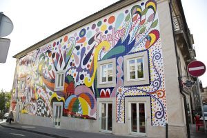 Colourful tiled mural covering the full facade of a two-storey Porto building
