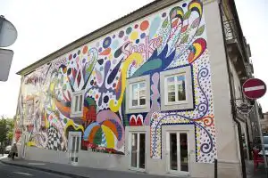 Colorful tiled mural covering the facade of a building on a Porto street corner