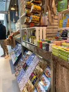Colorful Portuguese canned fish and souvenir tins displayed on wooden market shelves