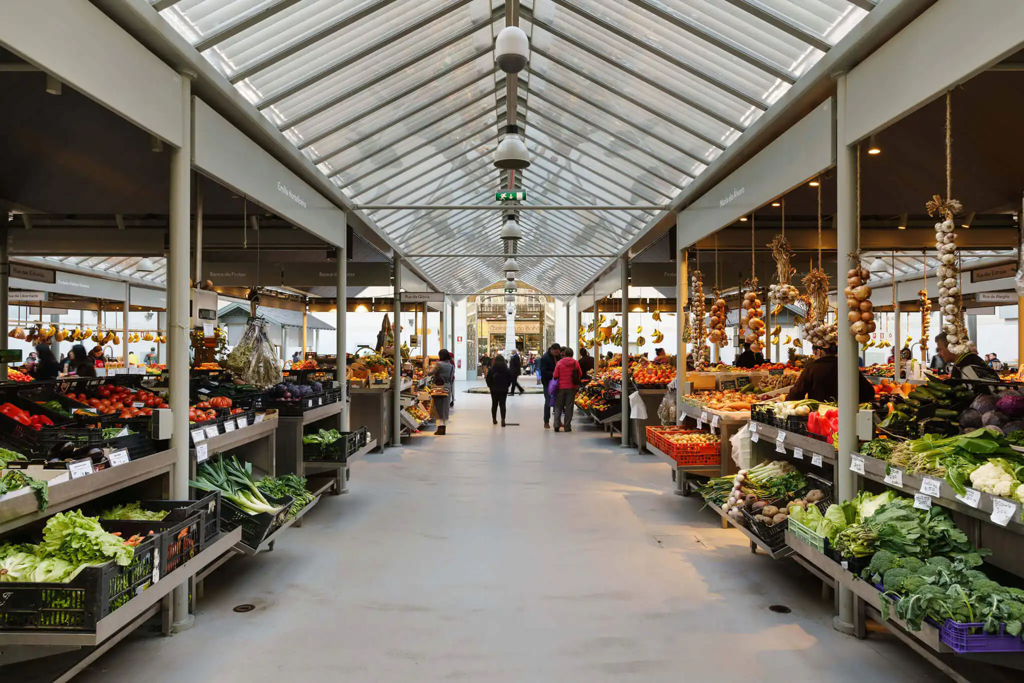 The produce aisles of Mercado do Bolhao in Porto, stacked with greens and vegetables