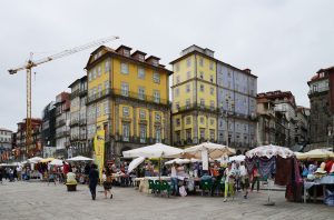 Colourful historic buildings and open-air market stalls at Ribeira square in Porto