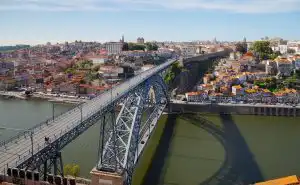 Ponte Luís I iron arch bridge spanning the Douro River with Porto's Ribeira district behind