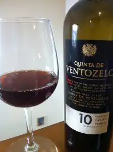Glass of tawny port beside a 10-year-old tawny porto bottle from Quinta de Ventozelo