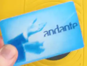 Andante transit card held up to a yellow card reader in Porto