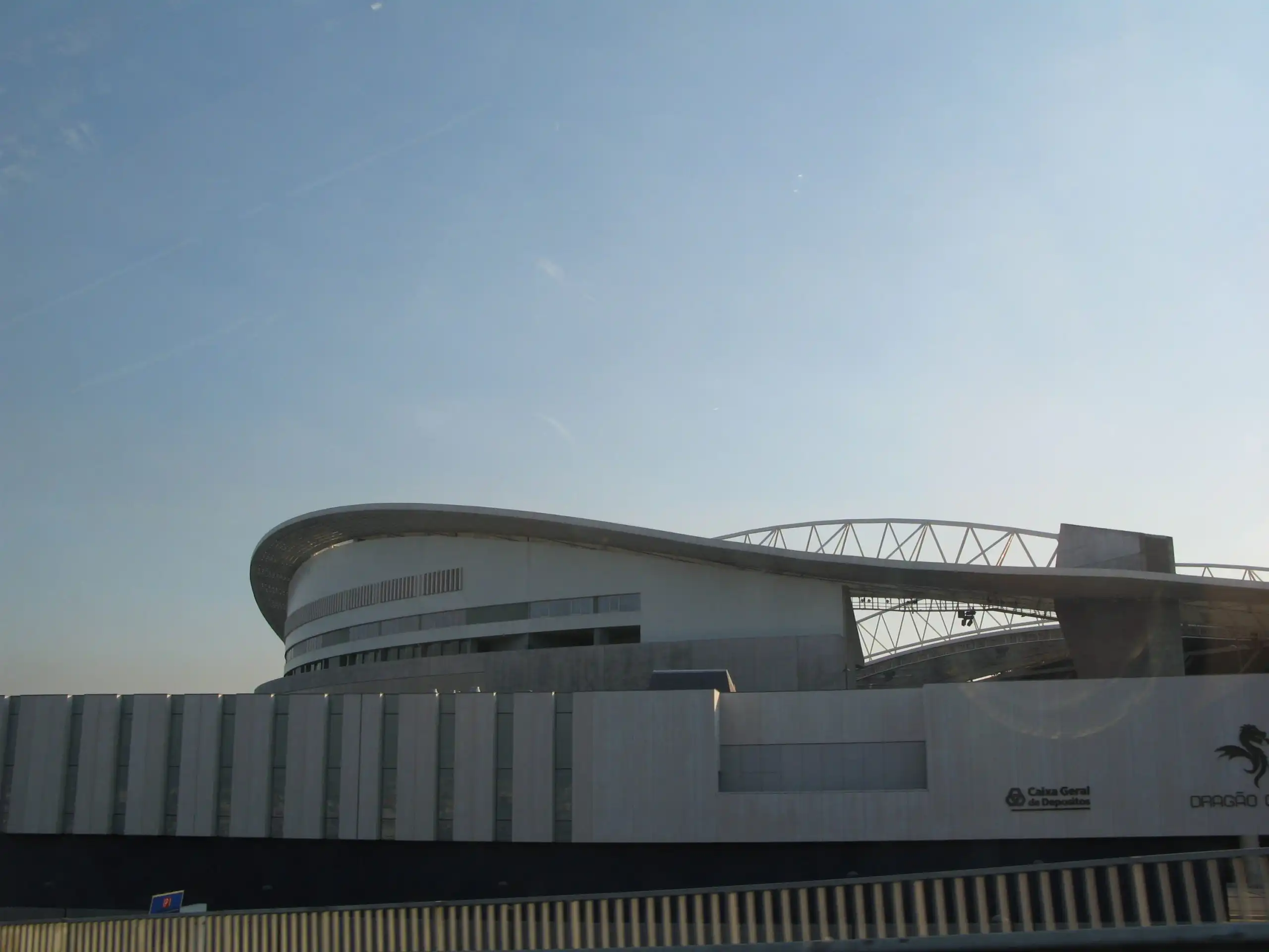 Estadio do Dragao in Porto seen from outside, showing its curved white roof and concrete facade